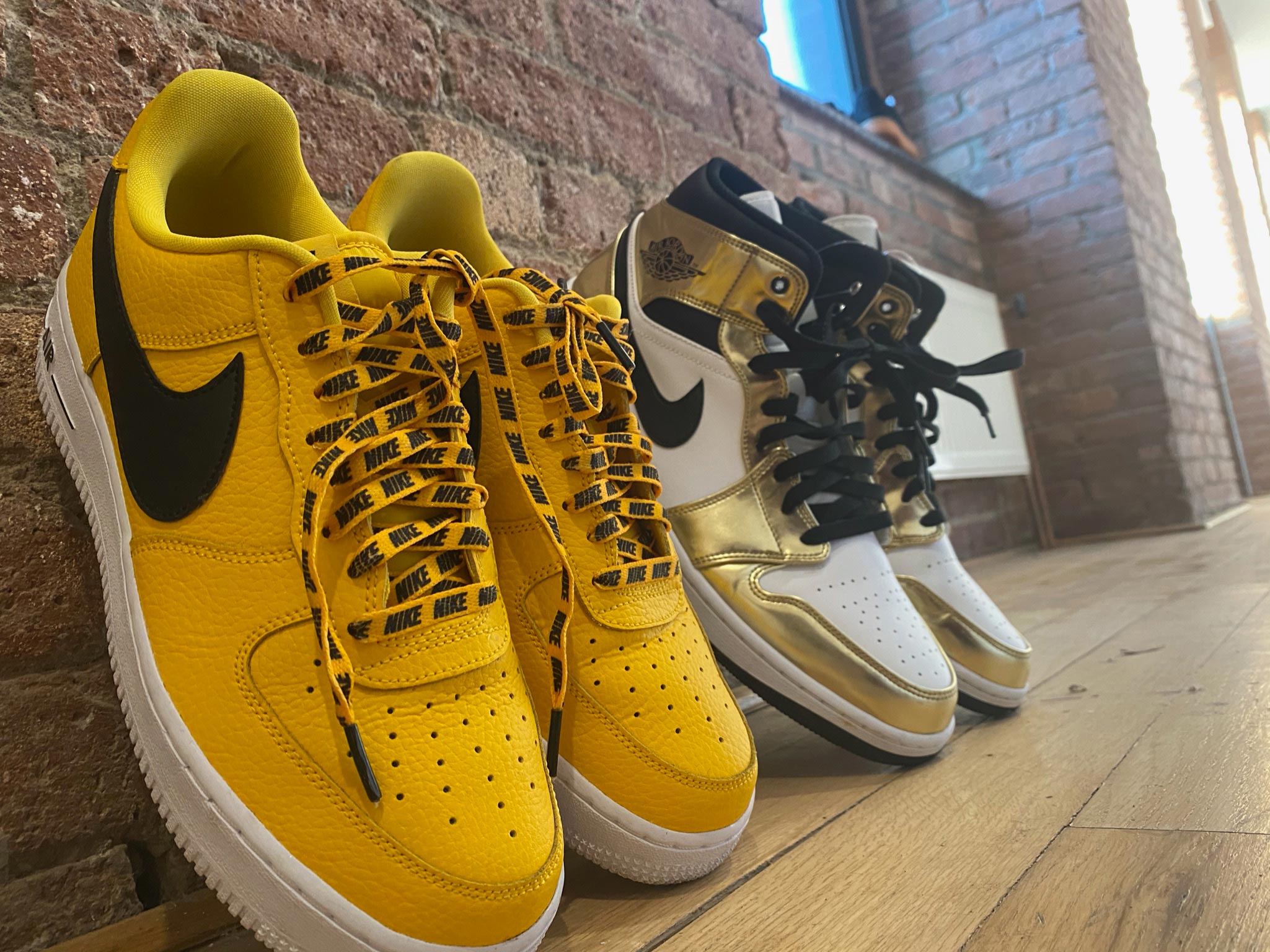 Yellow Nike sneakers and gold, black and white Nike Jordan's