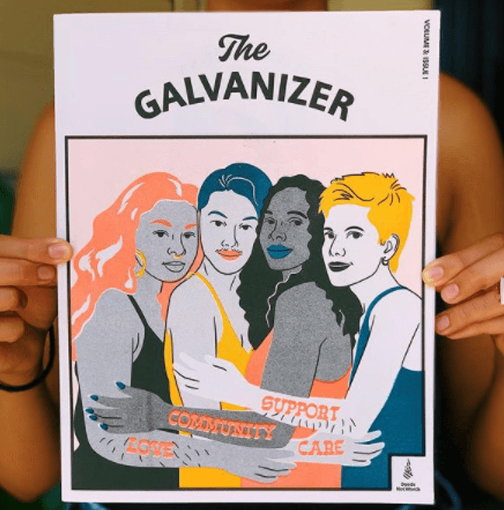 Close-up of person holding The Galvanizer magazine