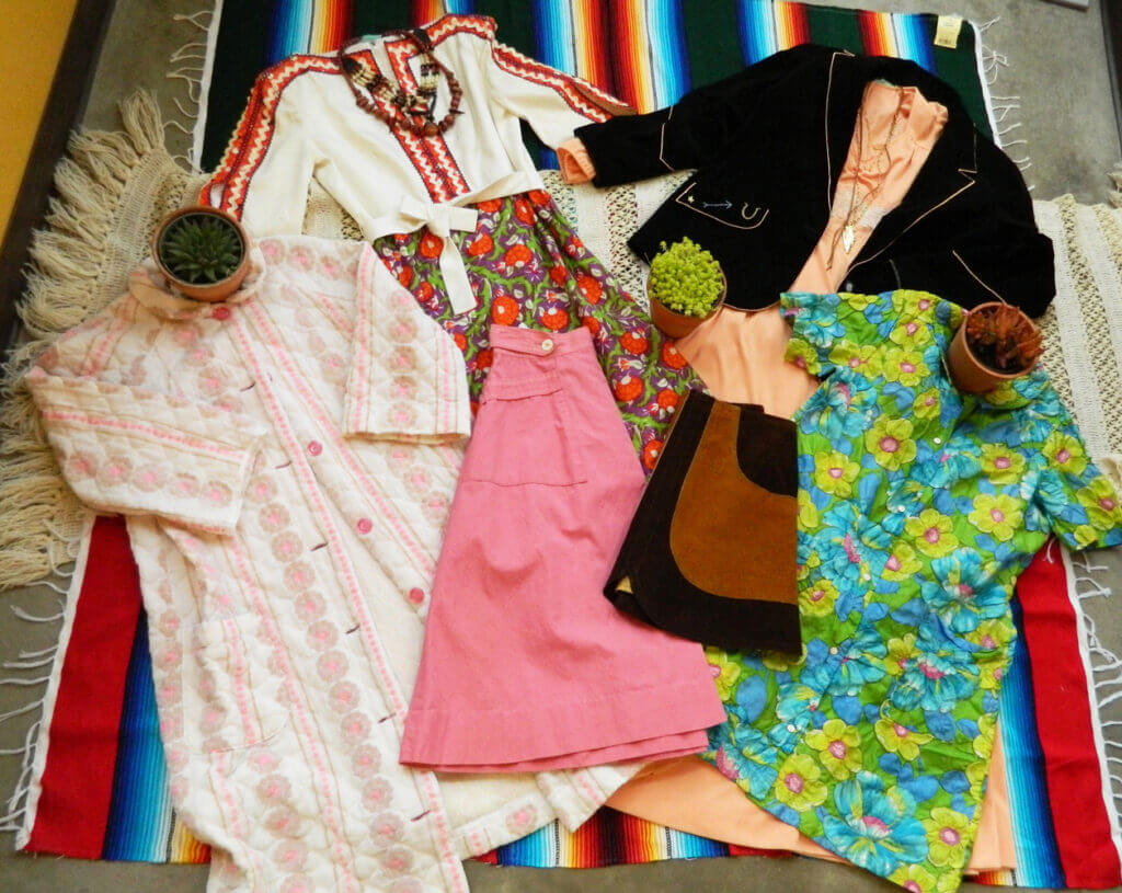Clothing laying on top of colorful tapestry