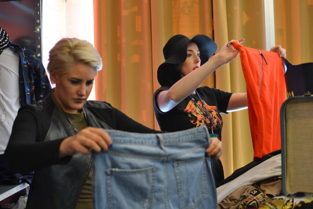 Two Buffalo Exchange Buyers, going through a buy