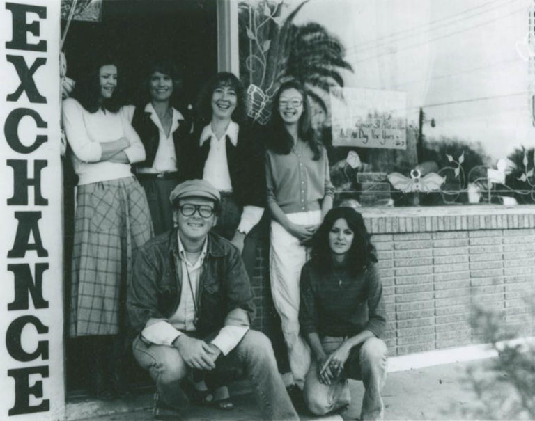 Men wearing a plaid sweater vest and brim hat