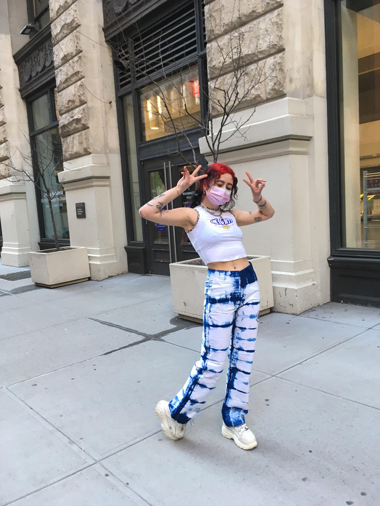 person wearing bleached denim paired with platform sneakers and cropped tank top