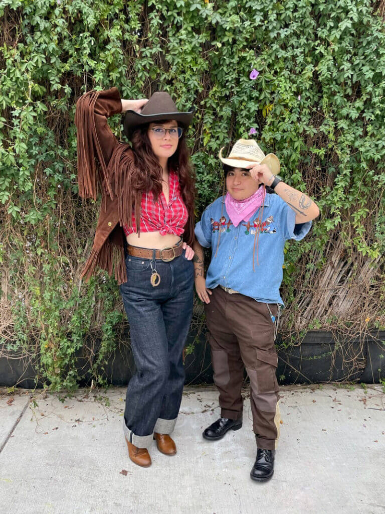 Two people wearing cowboy costumes