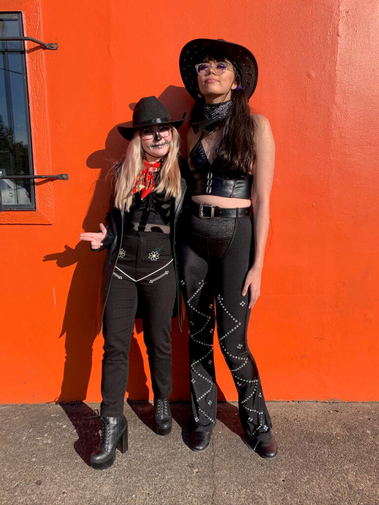 Two people wearing cowboy costumes