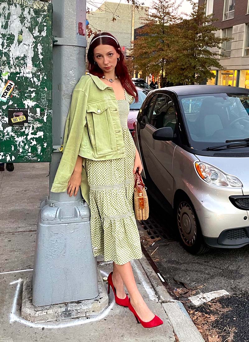 Person Wearing Green Checkered Dress, Green Denim Jacket & Red Heels On Side of Street