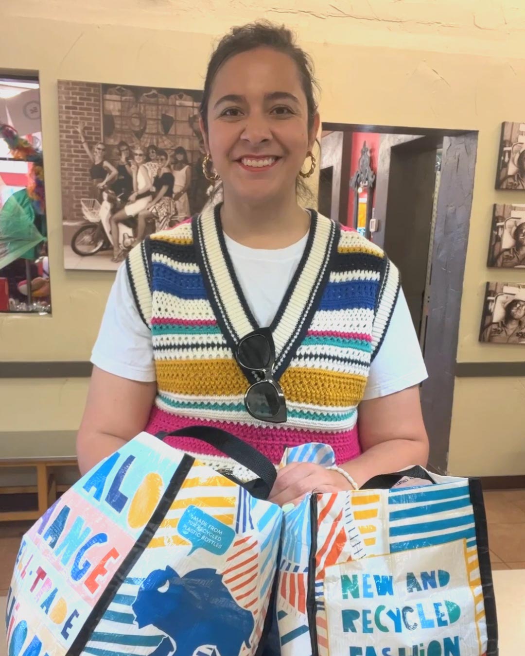 Buffalo Exchange  employee holding a lot of $1 bills with both hands