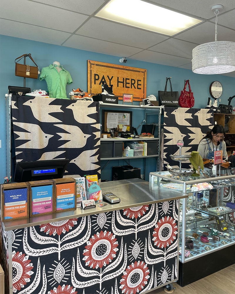 Checkout register area at Buffalo Exchange Eugene with sign that reads "Pay Here"