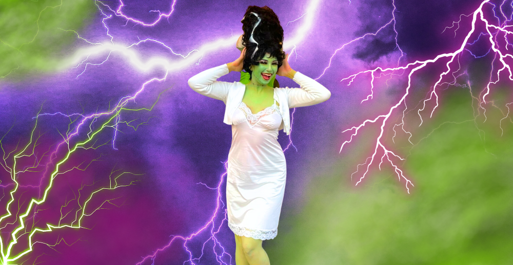 Person dressed as the Bride of Frankenstein on a stormy green, pink and purple background