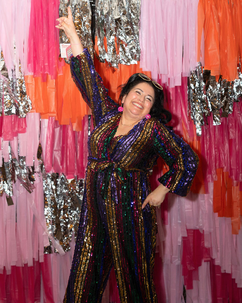 Monique in a sequined jumpsuit at Buffalo Exchange's 70s-themed 50th anniversary party