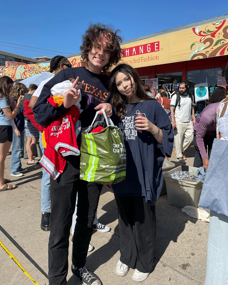 Two customers stand outside Buffalo exchange Earth Day sale with bags of clothes