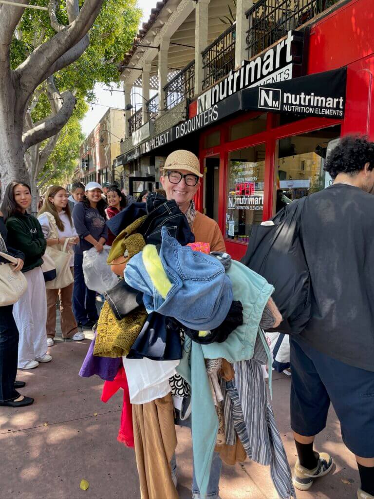 person holding a pile of clothes