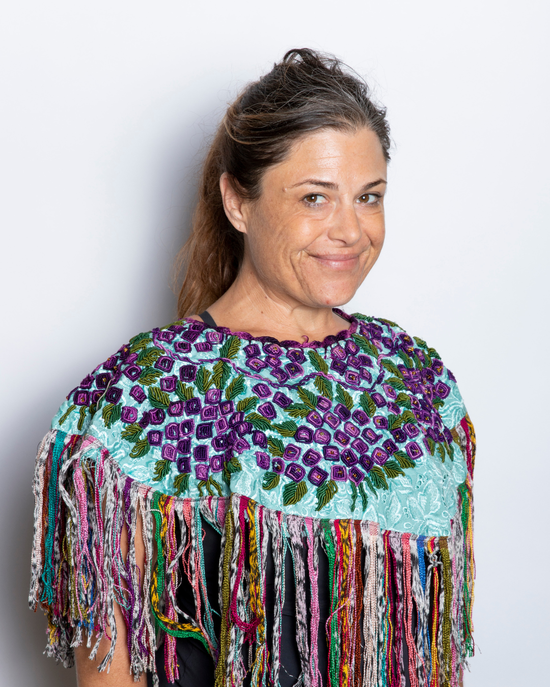 Denise wearing an embroidered multi-colored shawl