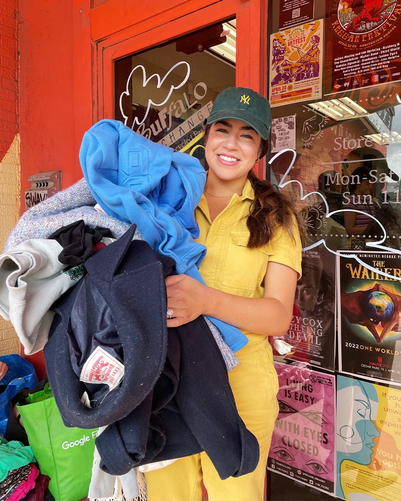 $1 sale shopper $1 sale shopper holding a bundle of clothes