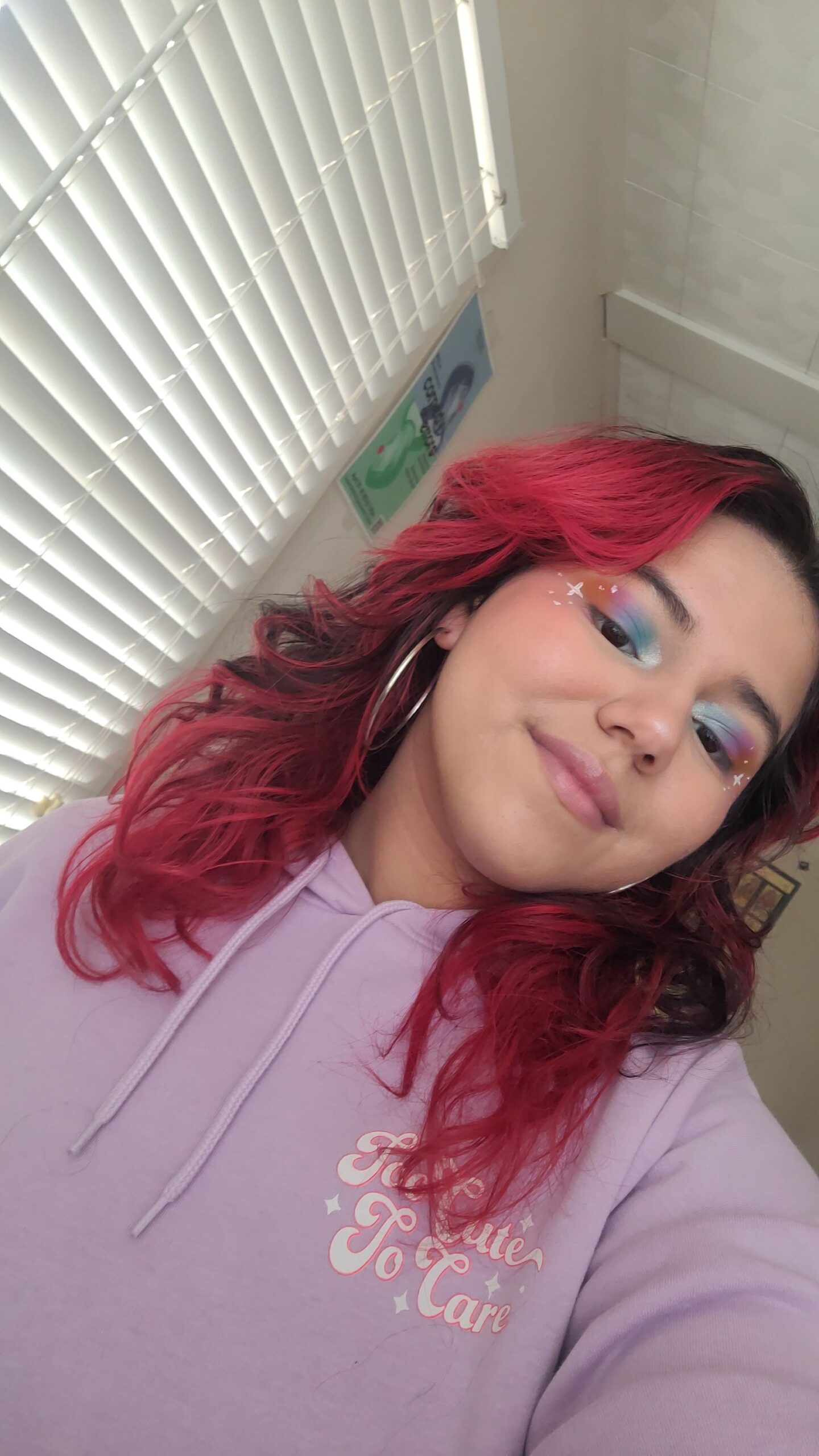 Joy posing with bright makeup