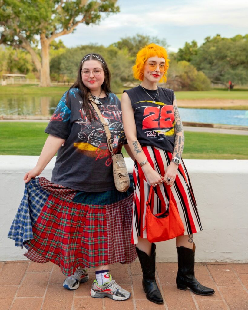 Two women wearing vintage racing tee shirts and skirts