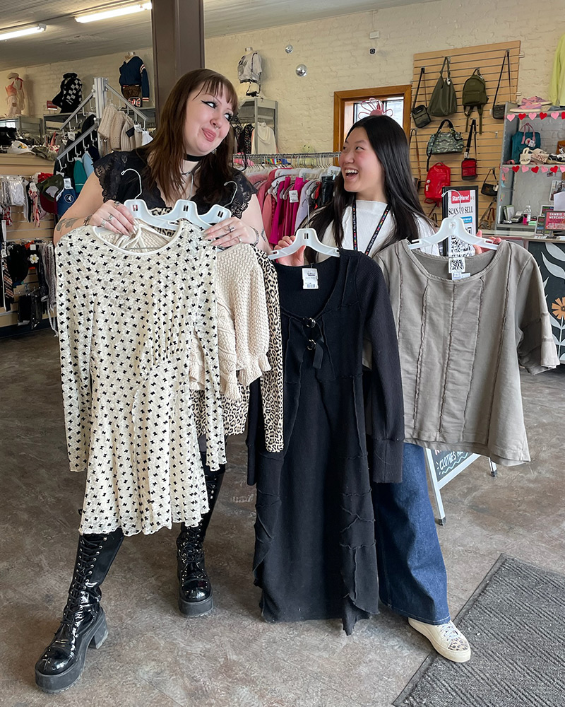 employee-friends Two employee friends holding clothes
