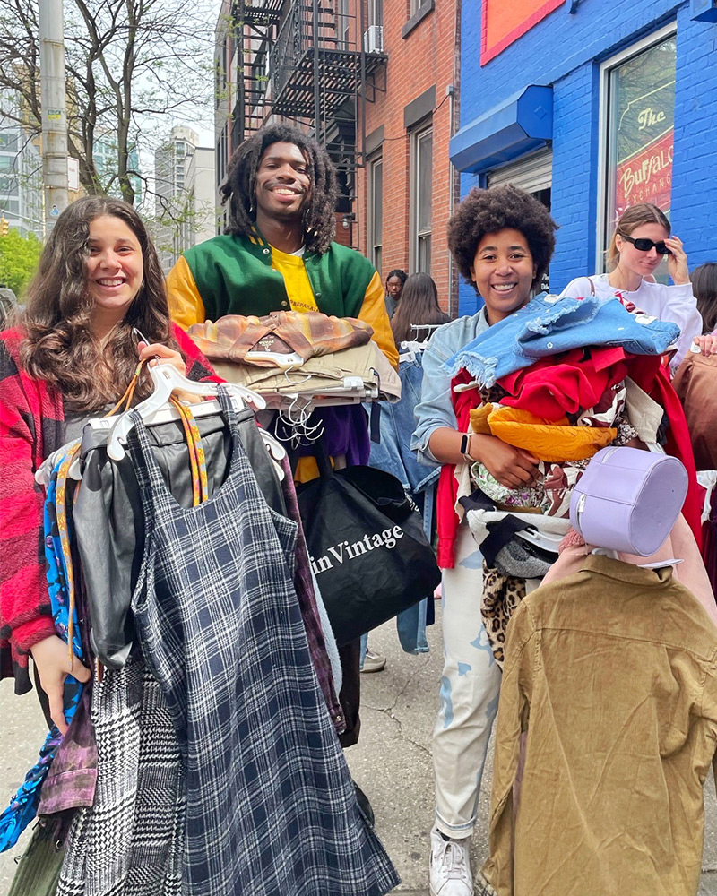 third-eday-pic Group of $1 sale customers with piles of clothes