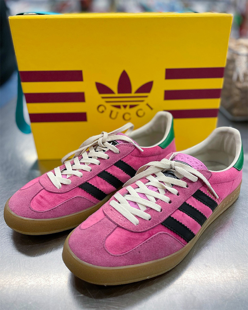 Blog-10-Edited Gucci x Adidas pink sneakers sit on top of a silver counter