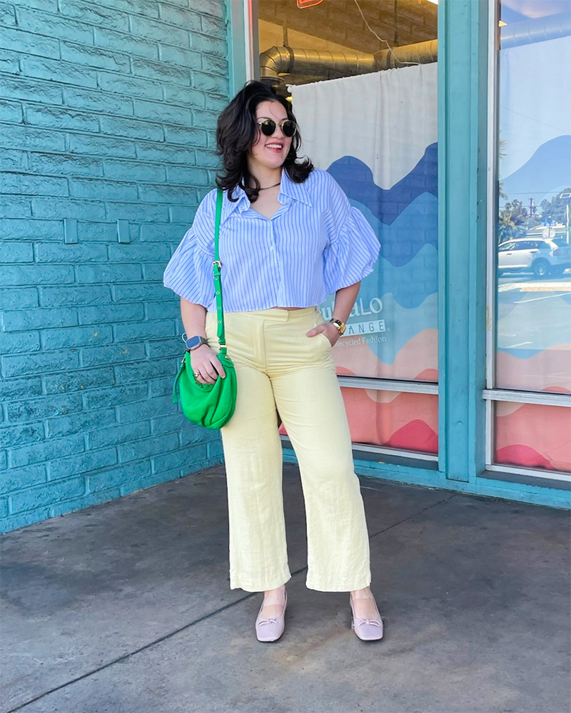 Blog-13-Edited Woman wearing striped light blue blouse, yellow pants, green handbag and pink ballet flats
