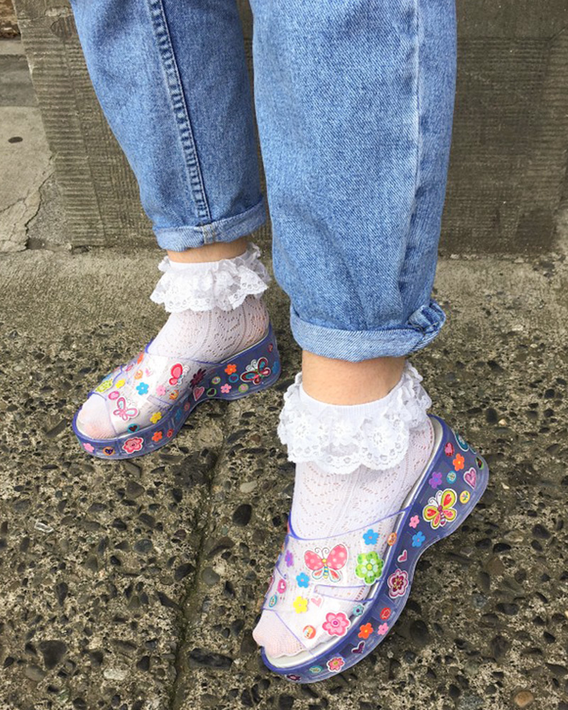 Blog-17-Edited Person wearing frilly socks and jelly sandals decorated with novelty stickers
