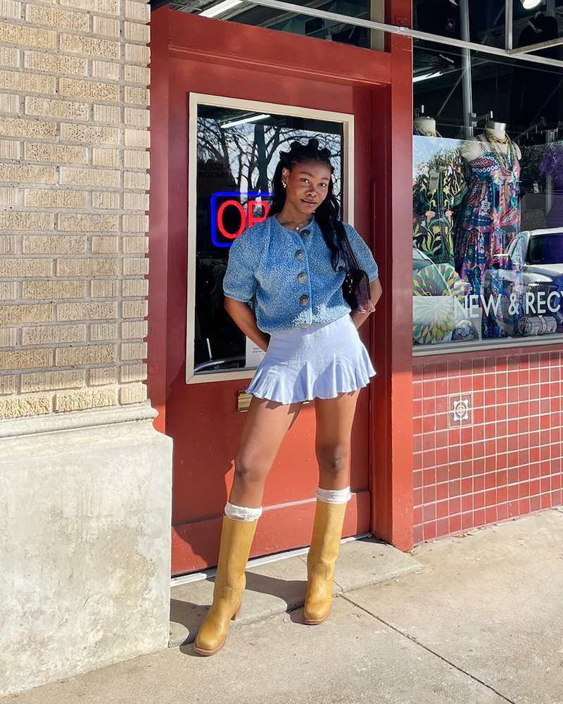 Blog-20-Edited A woman wearing a cropped blue sweater, blue shorts and tan Frye Campus boots