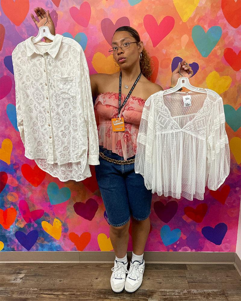 Blog-26-Edited A Buffalo Exchange employee holds up two sheer white blouses