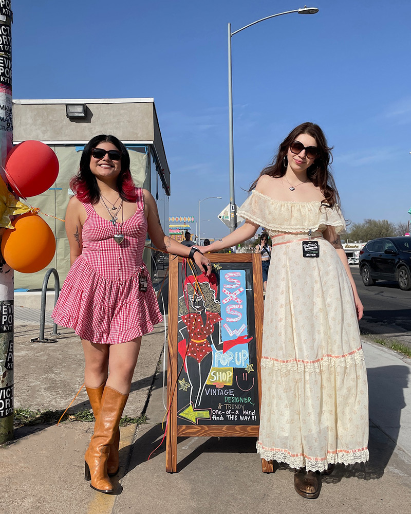 Blog-3-Edited Two women stand in the sun wearing vintage dresses and brown boots