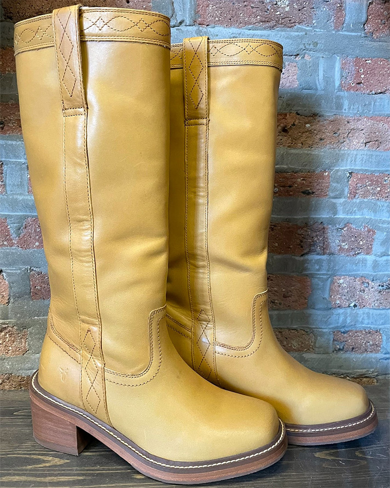 Blog-31-Edited Banana Frye Campus Boots sit on a shelf in front of brick wall