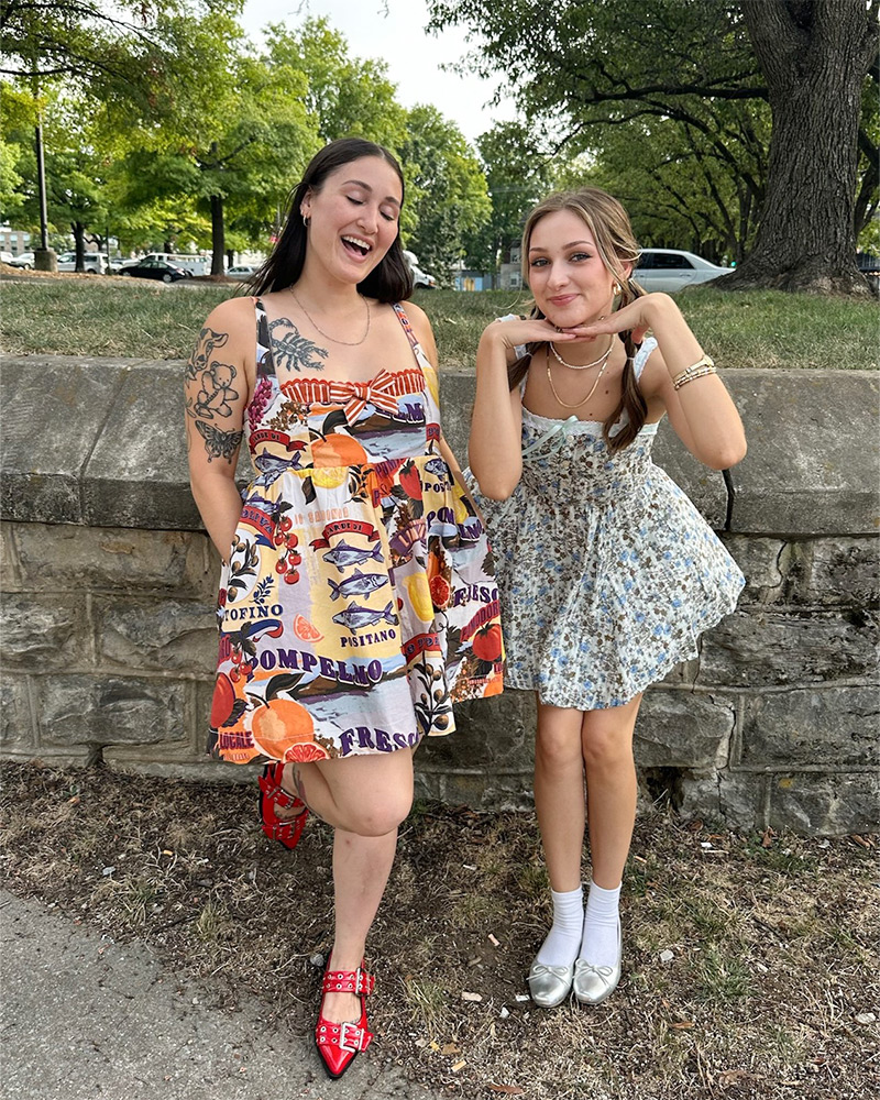 Blog-7-Edited Two women stand outside in a park wearing patterned sundresses