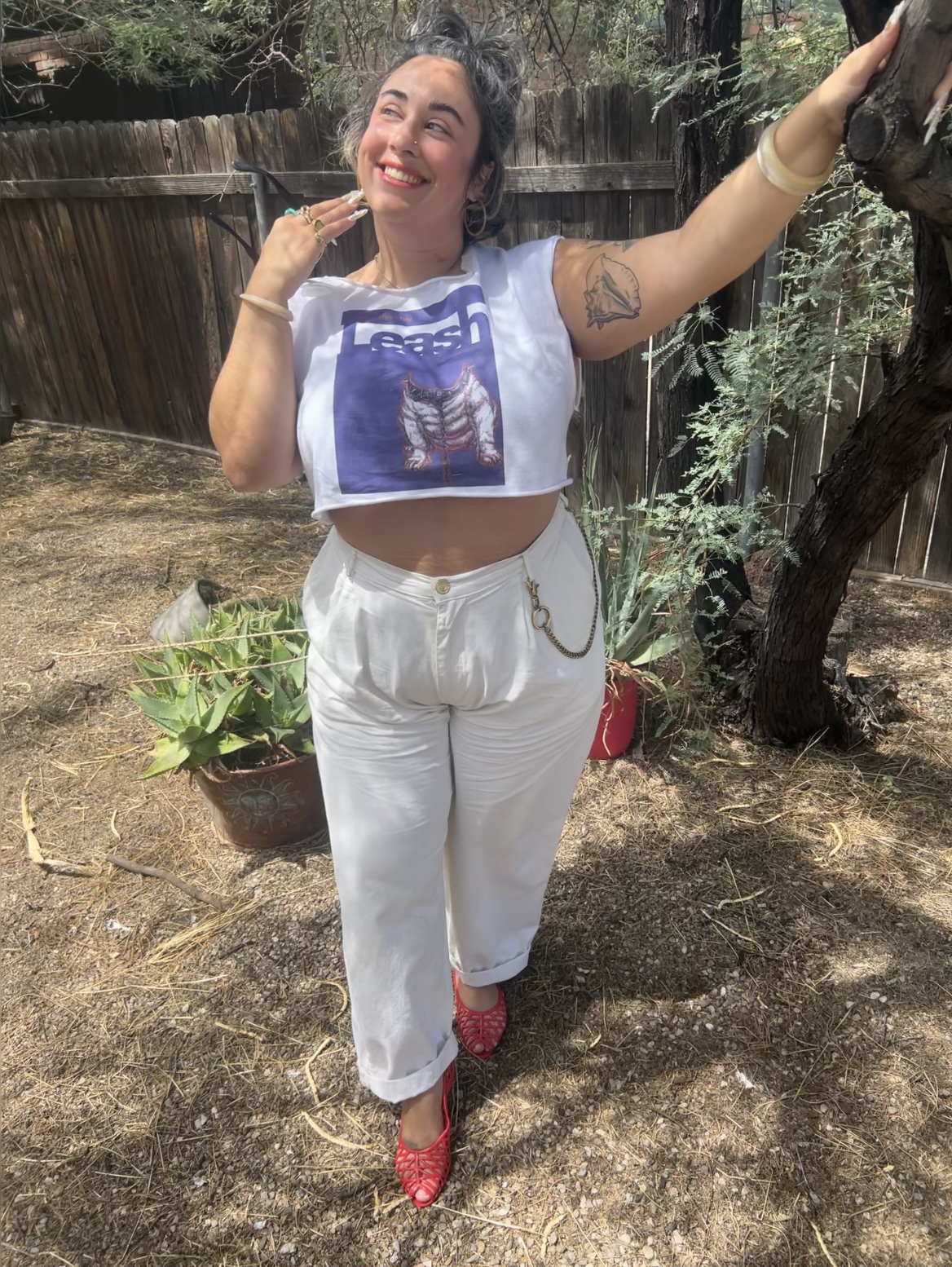 Employee Bianca posing outside next to a tree