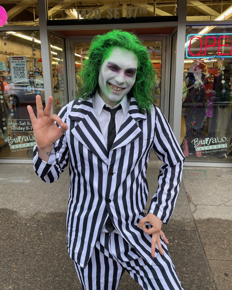 Person dressed as Beetlejuice in striped black and white suit