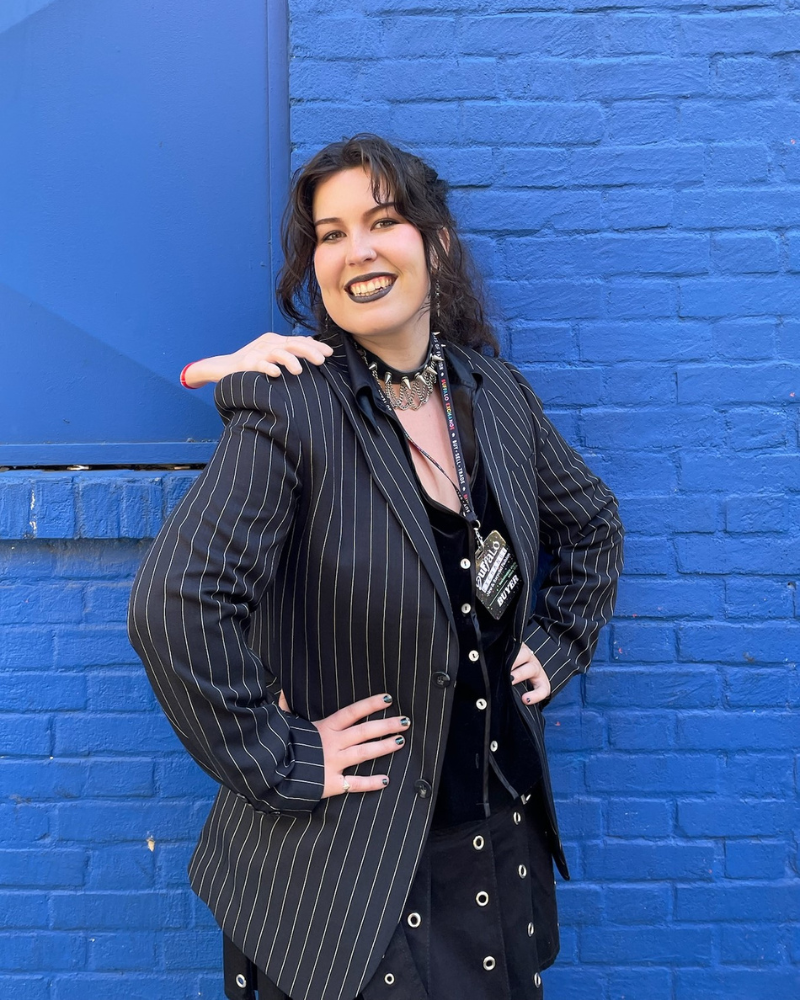 Buffalo Employee in pinstripe blazer with severed hand on shoulder