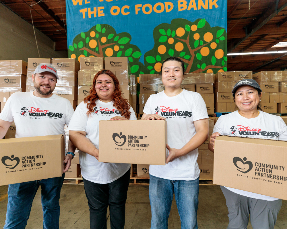 Community Action Partnership of Orange County members holding food bank boxes