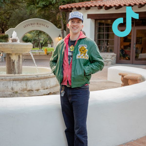 3 person standing in jeans and green vintage jacket with tiktok logo overlay
